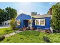 Quaint blue bungalow with black shutters, a well-maintained lawn, and charming curb appeal at 455 Wood Ave, Kannapolis, NC 28083