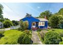 Charming blue house with a walkway, a well-manicured lawn and mature trees at 455 Wood Ave, Kannapolis, NC 28083