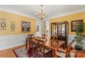 Formal dining room featuring a chandelier, wainscoting and a large wooden table at 4740 Myers Ln, Harrisburg, NC 28075
