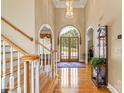 Stunning foyer with hardwood floors, chandelier, arched doorways, and staircase at 4740 Myers Ln, Harrisburg, NC 28075