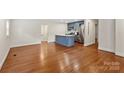 Spacious living room with hardwood floors and an adjacent kitchen area at 4906 Charleston Dr, Charlotte, NC 28212