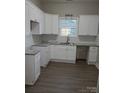 Bright kitchen featuring white cabinets, granite countertops, subway tile backsplash and modern fixtures at 518 N Fulton St, Salisbury, NC 28144