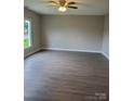 Spacious living room with hardwood flooring, neutral paint, and ample natural light from a large window at 518 N Fulton St, Salisbury, NC 28144