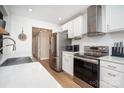 Bright kitchen with stainless steel appliances, sleek white cabinets, and quartz countertops at 5843 Timber Falls Nw Pl, Concord, NC 28027