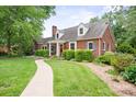 Brick home with a manicured lawn and landscaped path, showcasing classic architecture and curb appeal at 81 21St Nw Ave, Hickory, NC 28601