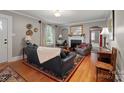 Inviting living room with hardwood floors, fireplace, and large windows that provide natural light at 81 21St Nw Ave, Hickory, NC 28601