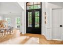 Bright foyer featuring a modern double front door, wood floors, and a glimpse of the well lit living area at 8500 Headford Rd, Charlotte, NC 28277