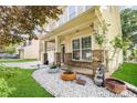 Inviting front porch with decorative plants, stone accents and a cozy entryway to this house at 10105 Community House Rd, Charlotte, NC 28277