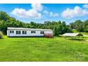 Home exterior featuring well-maintained lawn and outdoor covered parking at 1016 S D Ave, Maiden, NC 28650