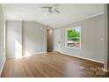 Spacious living room with neutral paint, ceiling fan, and hardwood flooring at 1016 S D Ave, Maiden, NC 28650