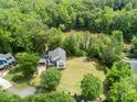 Expansive backyard features an outdoor firepit and lush tree line, backing up to a tranquil creek at 1062 Willow Ridge Ln, Fort Mill, SC 29707