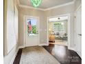Foyer boasts hardwood floors, a decorative light fixture, and views into the living room at 1226 Restoration Dr, Waxhaw, NC 28173