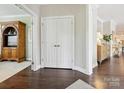 Hallway with hardwood floors leading to other areas of the home, showcasing neutral wall colors at 1226 Restoration Dr, Waxhaw, NC 28173