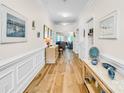 Bright hallway with beautiful hardwood floors, classic wall paneling and stylish decor at 12910 Meetinghouse Dr, Cornelius, NC 28031