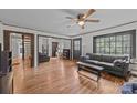 Spacious living room with hardwood floors, large windows, and access to other rooms at 147 Hansard Dr, Charlotte, NC 28214
