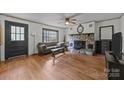 Bright living room features a stone fireplace, hardwood floors, and large windows at 147 Hansard Dr, Charlotte, NC 28214