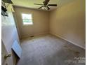 A modest bedroom with carpet flooring, light pink walls, and a ceiling fan at 1616 Lazenby St # 17, Newton, NC 28658