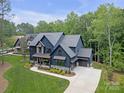 Expansive aerial view of a stunning home with mature trees and a long driveway leading to a large garage at 18238 Youngblood N Rd, Charlotte, NC 28278