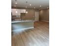 The open-concept kitchen features granite countertops and flows seamlessly into the dining area at 210 Johnson St, Troutman, NC 28116