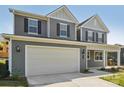 Two-story home featuring gray siding, a two-car garage, and a welcoming front porch at 220 Windy Dell Dr, Tega Cay, SC 29708