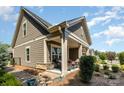 Cozy side porch with comfortable seating and lush landscaping, creating a relaxing outdoor space at 2245 Lincolnshire Ln, Waxhaw, NC 28173