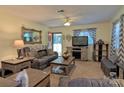 Living room featuring neutral colors, a ceiling fan, and an exterior door at 252 Chuckwood Rd, Mooresville, NC 28117