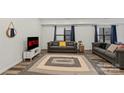 Cozy living room featuring modern decor, stylish furniture, and wood flooring at 2813 Ava Ave, Charlotte, NC 28208