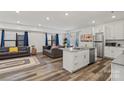 Open floorplan showcasing a modern kitchen, living area, and wood flooring at 2813 Ava Ave, Charlotte, NC 28208