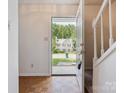 Inviting entryway with wood flooring and a view of the home across the street through the open front door at 3313 Fortis Ln, Matthews, NC 28105