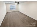 A basic bedroom with light colored walls, carpeted floors, one window and a ceiling fan with lighting at 3486 Duchess Ave, Fort Mill, SC 29707