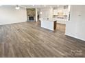 Spacious open floor plan with wood flooring, a fireplace, and a kitchen island, offering a modern feel at 3486 Duchess Ave, Fort Mill, SC 29707