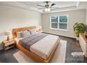 Comfortable main bedroom featuring a tray ceiling, a large window, and modern furnishings at 3486 Duchess Ave, Fort Mill, SC 29707