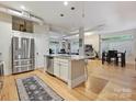 Bright open concept kitchen with island, stainless appliances, and hardwood floors at 404 N Laurel Ave # 11, Charlotte, NC 28204