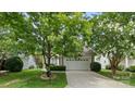View of the home's exterior featuring an attached garage, driveway, and landscaped yard at 424 Paperbark Ln, Rock Hill, SC 29732