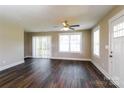 Bright living room features hardwood floors, a ceiling fan, and access to the deck at 515 Kings Mountain St, Clover, SC 29710