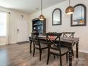 A stylish dining room with a dark table and chairs, decorative mirrors, and modern lighting at 5432 Kinsbridge Dr, Charlotte, NC 28227