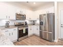 Modern kitchen featuring stainless steel appliances, granite countertops, and ample white cabinetry at 5432 Kinsbridge Dr, Charlotte, NC 28227