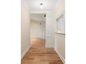 Inviting hallway with hardwood floors, neutral paint, and decorative molding at 5601 Fairview Rd # 11, Charlotte, NC 28209