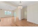 Spacious living room with hardwood floors, a chandelier, and natural light at 5601 Fairview Rd # 11, Charlotte, NC 28209