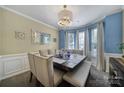 Elegant dining room with bay window, decorative lighting, and a table set for a formal dinner at 920 Old Forester Ln, Charlotte, NC 28214