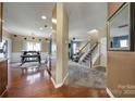 Inviting foyer with hardwood flooring, leading to the dining area, staircase, and carpeted living room at 920 Old Forester Ln, Charlotte, NC 28214