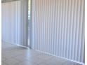 Living room with large sliding glass doors and vertical blinds at 9501-A Shannon Green Dr, Charlotte, NC 28213