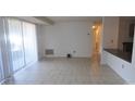 Bright living room featuring ceramic tile flooring and a walkout patio at 9501-A Shannon Green Dr, Charlotte, NC 28213