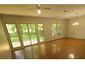 Bright living room featuring hardwood floors, ceiling fan, and sliding glass doors to the backyard at 109 Phil Ct, Fort Mill, SC 29715