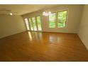 Spacious living room with hardwood floors, a ceiling fan, and natural light from the windows at 109 Phil Ct, Fort Mill, SC 29715