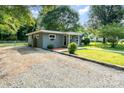 Well-maintained home features a gravel driveway, manicured lawn and a charming exterior at 112 Lineberger St, Stanley, NC 28164