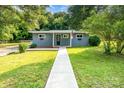 Charming single-story home boasts a freshly painted exterior, manicured lawn and inviting walkway at 112 Lineberger St, Stanley, NC 28164