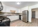 Bright kitchen with white cabinets, stainless appliances, and a stylish backsplash with a modern look at 112 Lineberger St, Stanley, NC 28164