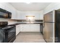 Bright kitchen with white cabinets, stainless appliances, and a stylish backsplash creating a modern culinary space at 112 Lineberger St, Stanley, NC 28164
