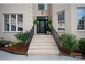 Inviting front entrance featuring stone steps and decorative landscaping with hanging ferns at 11841 Churchfield Ln, Charlotte, NC 28277